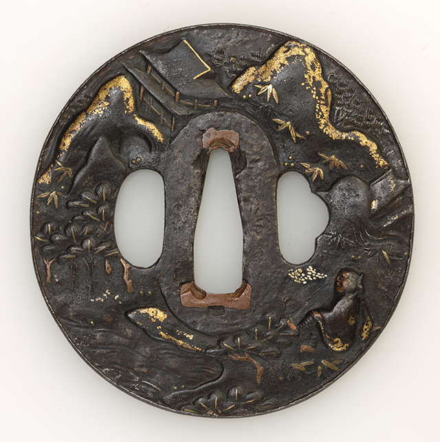 素材 銅　金
形 丸
櫃孔 両櫃孔
技法 鋤残耳 高彫　象嵌 色絵

特徴 凹凸変化に富み、図柄の立体感が特徴的な鐔です。象嵌の種類も多様で点状や金布目、据文と細かく技巧を凝らしています。旅姿の侍が山水に楼閣の聳える雄大な景色の中で座して憩う姿をあらわしています。

状態　良好です。